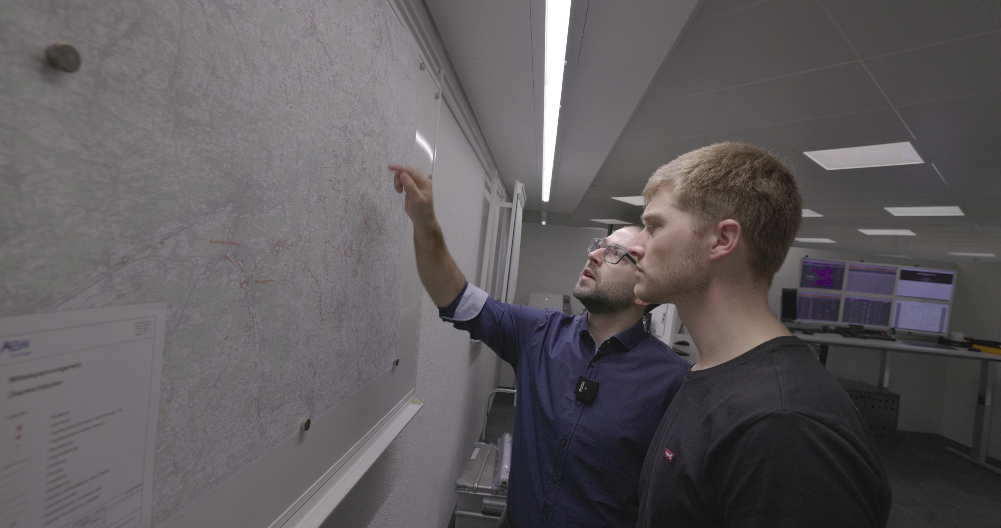 The team discuss at a map