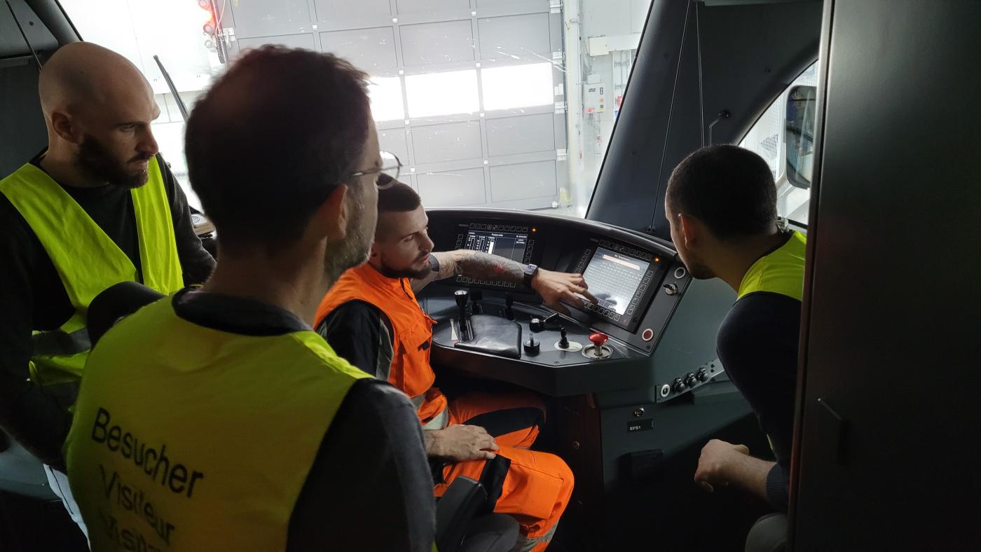 Four men inside the train driver's cabin